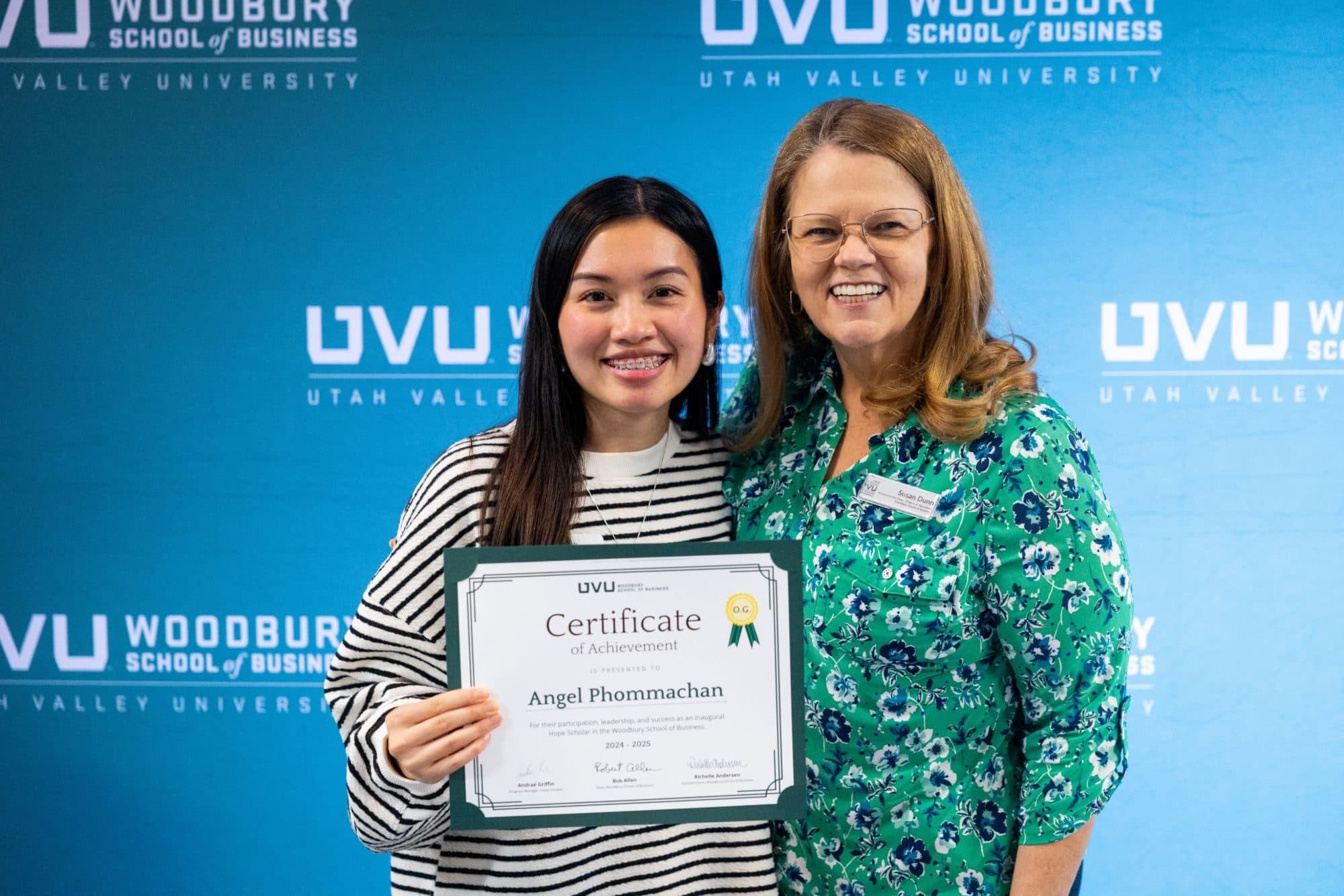 Angel Phommachan holding her Woodbury School of Business Certificate of Achievement as an inaugural Hope Scholar, 2024 to 2025