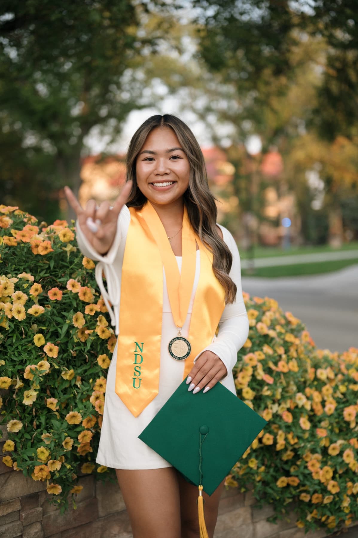 North Dakota State University graduate with flowers