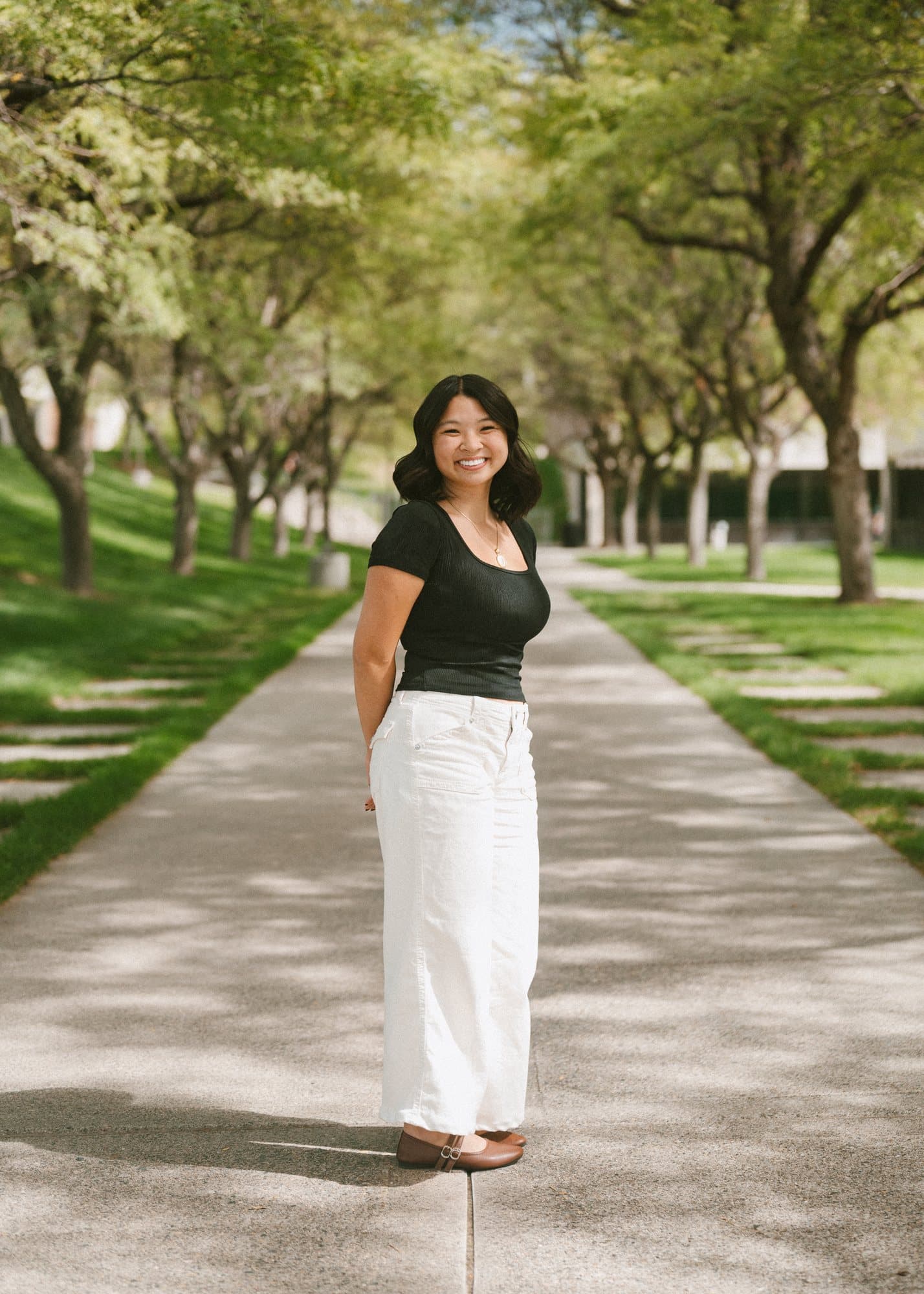 Portrait on a tree-lined campus walkway
